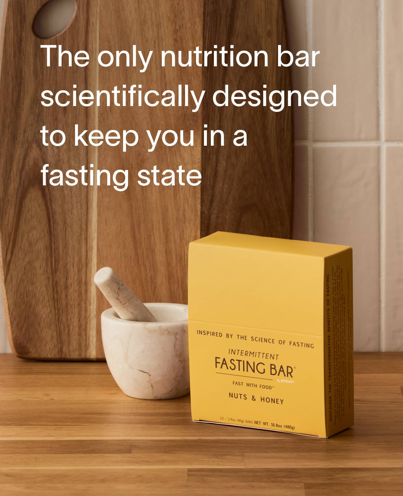 Prolon Fasting Bar Nuts and Honey box on a wood cutting board